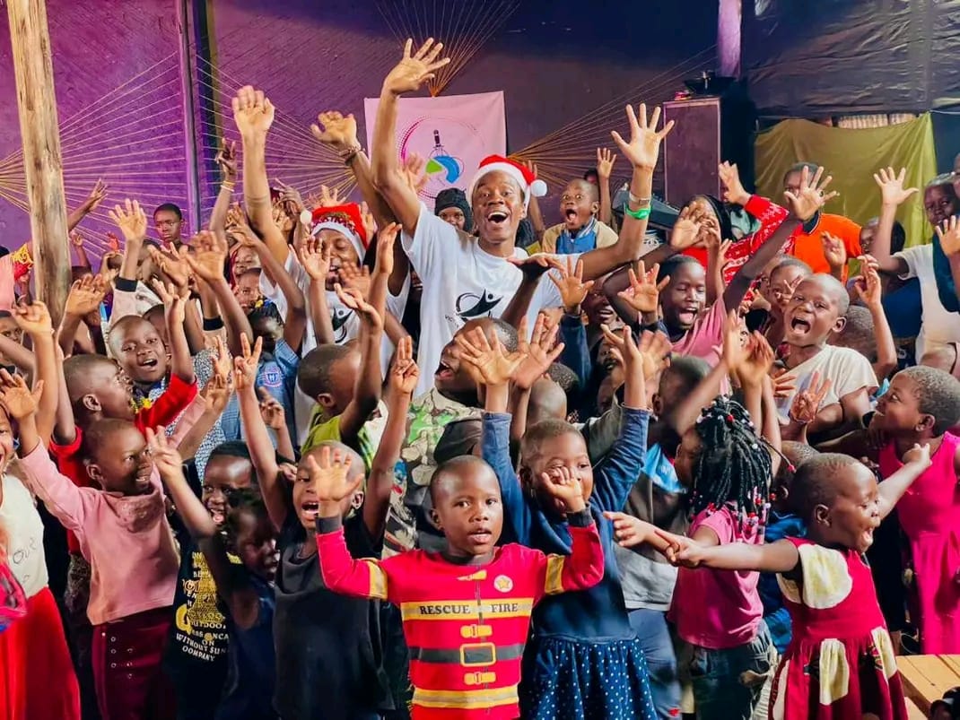 Children cheering with their hands raised during the Christmas celebration
