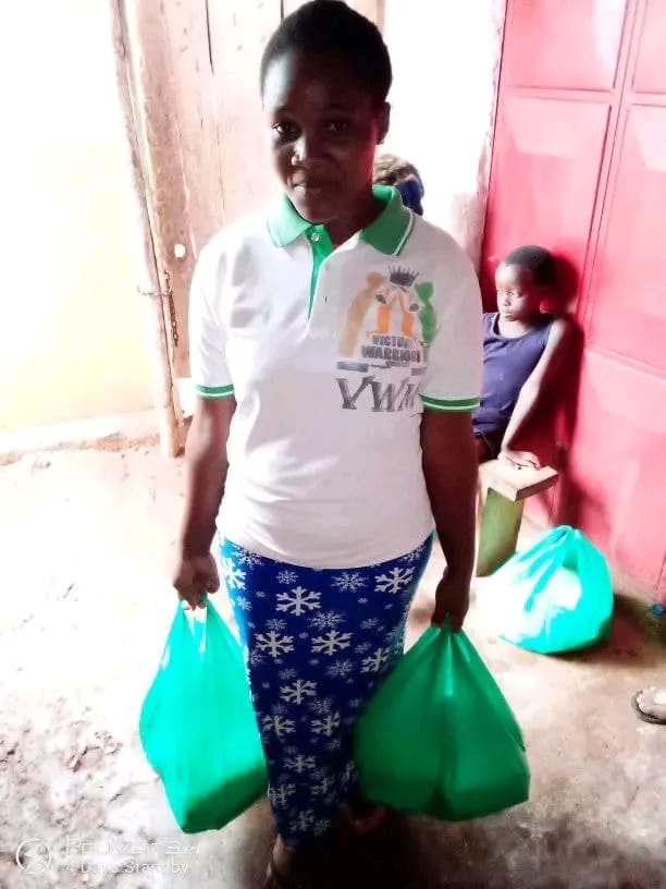 A woman carrying bags of relief food supplies to distribute