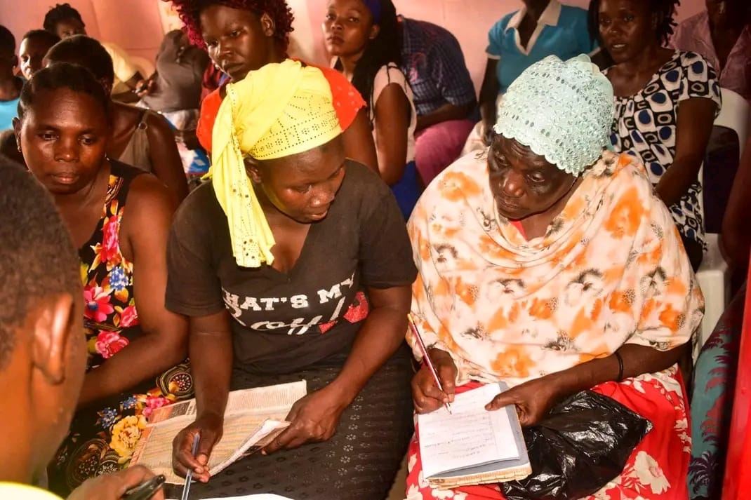 Women writing notes during a community education session