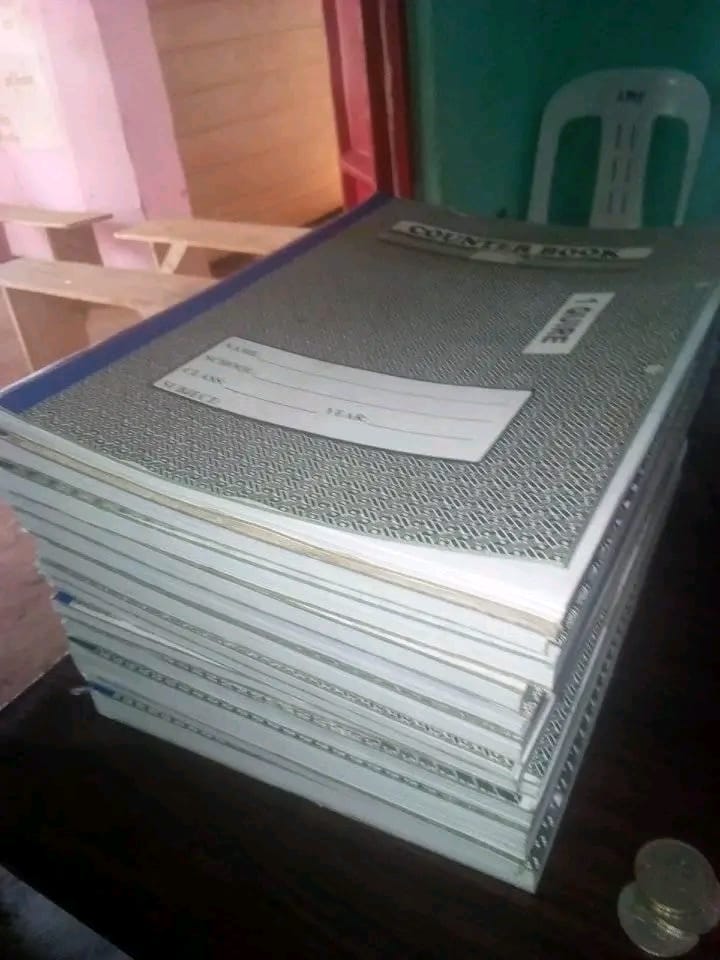 A stack of completed schoolbooks produced by the group