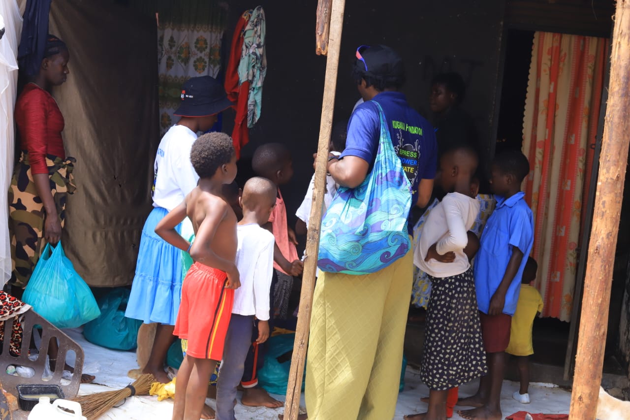 Volunteers handing out food supplies and clothing during the community outreach